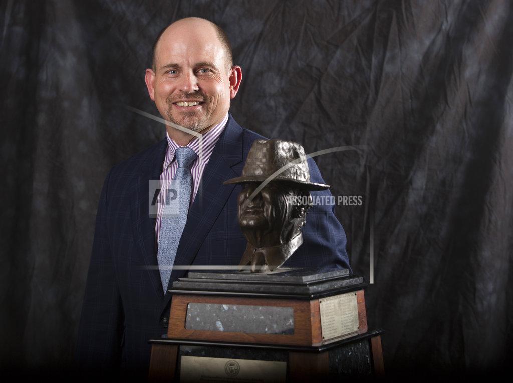 Yi-Chin Lee UAB coach Bill Clark poses for a photograph with the Paul "Bear" Bryant Coach of the Year Award, before the ceremony Wednesday, Jan. 9, 2019, in Houston. (Yi-Chin Lee/Houston Chronicle via AP)