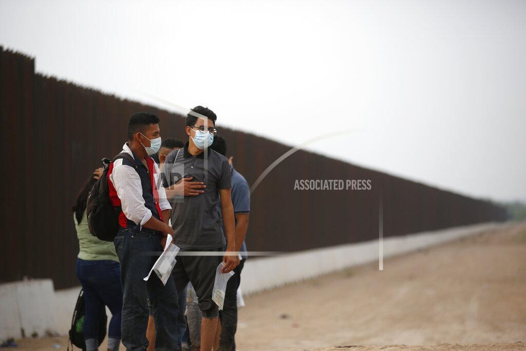 Dario Lopez-Mills Migrants who had crossed the Rio Grande river into the U.S. wait to be processed by U.S. Border Patrol agents in Eagle Pass, Texas, Friday, May 20, 2022. As U.S. officials anxiously waited, many of the migrants crossing the border from Mexico on Friday were oblivious to a pending momentous court ruling on whether to maintain pandemic-related powers that deny a chance to seek asylum on grounds of preventing the spread of COVID-19. (AP Photo/Dario Lopez-Mills)