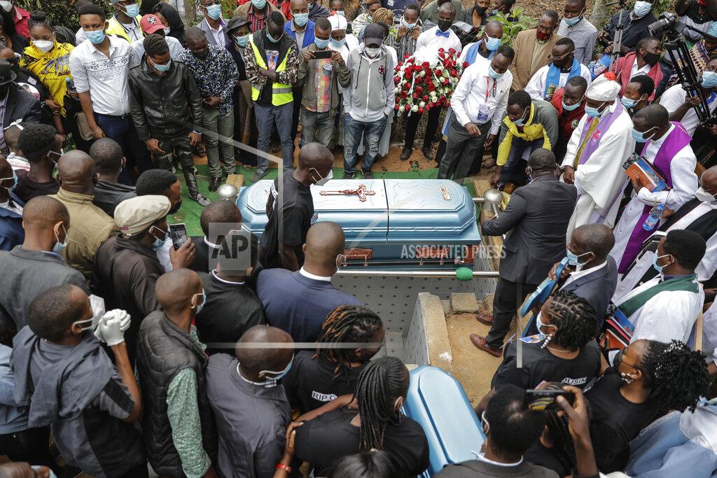 Brian Inganga Mourners prepare to bury coronavirus victim 27 year old Nancy Ndanu Musyoka, with her daughter Jaylla Musyoka, in Kakungu village, Kitui county, Kenya, Wednesday, July 28, 2021. Nancy, a high school teacher started feeling unwell and was taken to Kitui referral hospital with breathing complications. (AP Photo/Brian Inganga)