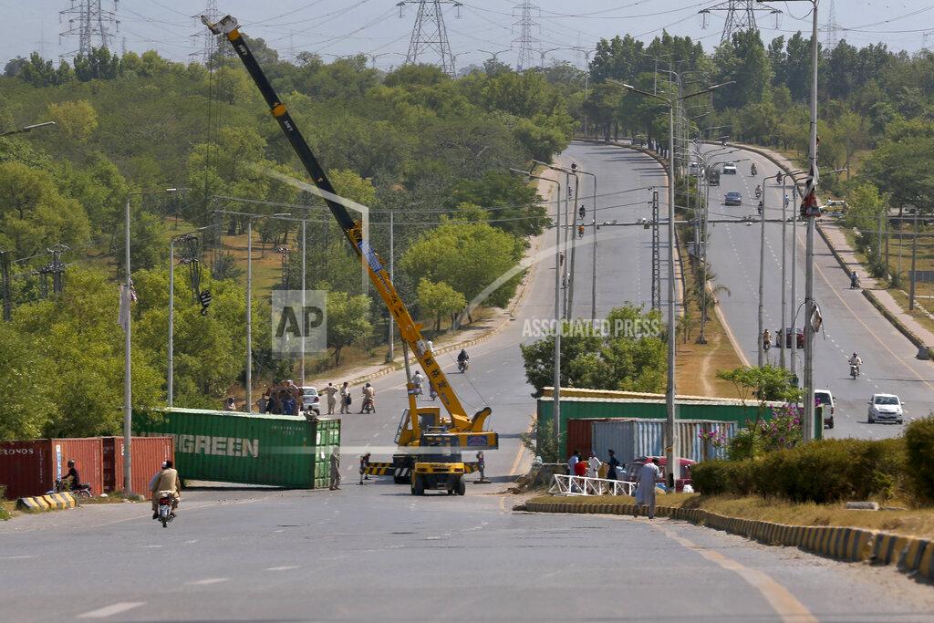 Anjum Naveed Authorities place shipping containers to block a road leading to capital city in an attempt to foil a planned rally, in Islamabad, Pakistan, Wednesday, May 25, 2022. Pakistani authorities blocked off all major roads into the capital Islamabad on Wednesday, after a defiant former Prime Minister Imran Khan said he would march with demonstrators to the city center for a rally he hopes will bring down the government and force early elections.(AP Photo/Anjum Naveed)