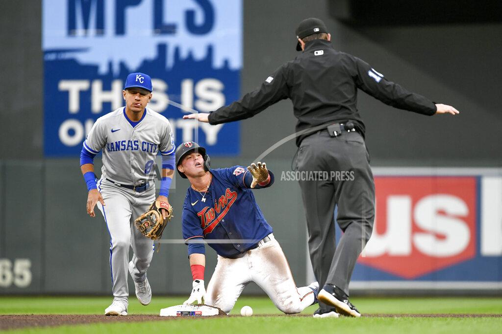 Craig Lassig Umpire Adam Beck, right, calls Minnesota Twins' Jose Miranda, center, safe at second base with a double, next to Kansas City Royals second baseman Nicky Lopez during the fourth inning of a baseball game Thursday, May 26, 2022, in Minneapolis. (AP Photo/Craig Lassig)