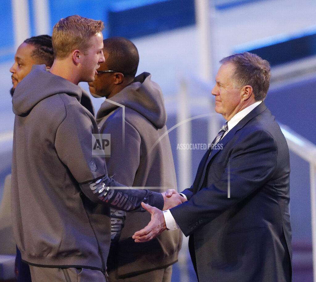John Bazemore New England Patriots head coach Bill Belichick talks to Los Angeles Rams' Jared Goff during Opening Night for the NFL Super Bowl 53 football game Monday, Jan. 28, 2019, in Atlanta. (AP Photo/John Bazemore)