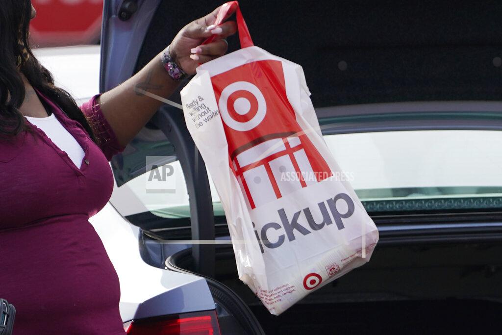 Rogelio V. Solis A Target employee places a curbside pickup purchase into the trunk of a customer in Jackson, Miss., Thursday, Nov. 5, 2020. After a weak start to the holiday season for many mall-based retailers, the strugglers are making their final push in the final days before and the week after Christmas. Many are stepping up discounts while heavily promoting curbside pickup as a way to get shoppers, worried about being infected with the virus, to visit their stores. But experts believe that any burst of sales will be too little and too late to save some stores. (AP Photo/Rogelio V. Solis)