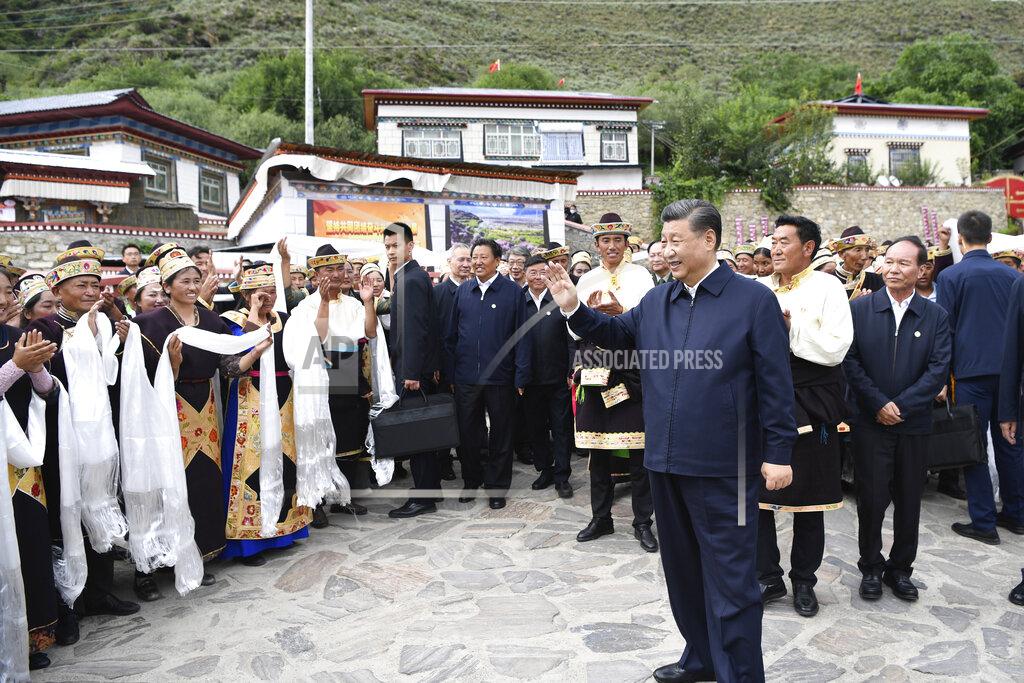 Shen Hong In this photo released by Xinhua News Agency, Chinese President Xi Jinping, waves to villagers while visiting Galai village of Nyingchi, southwest China's Tibet Autonomous Region, Wednesday, July 21, 2021. Chinese leader Xi Jinping has made a rare visit to Tibet as authorities tighten controls over the Himalayan region's traditional Buddhist culture, accompanied by an accelerated drive for economic development. (Shen Hong/Xinhua via AP)