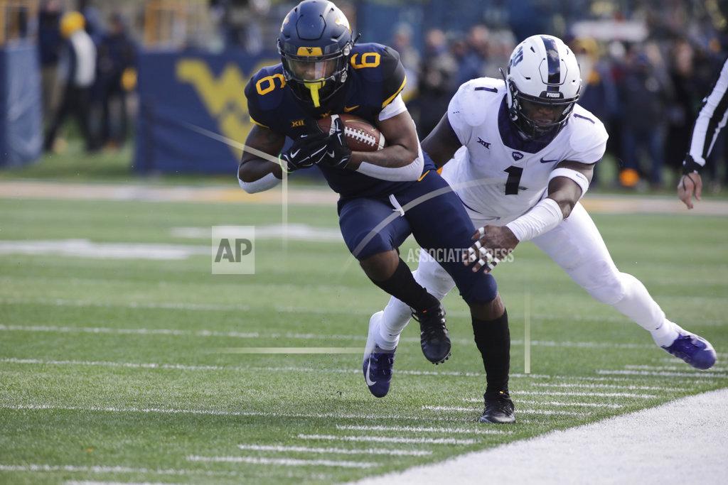 Ray Thompson West Virginia running back Kennedy McKoy (6) is tackled by TCU linebacker Jawuan Johnson (1) during the first half of an NCAA college football game Saturday, Nov. 10, 2018, in Morgantown, W.Va. (AP Photo/Raymond Thompson)