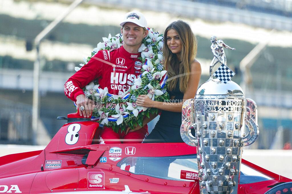 Michael Conroy Marcus Ericsson, of Sweden, poses with girlfriend Iris Tritsaris Jondahl and the Borg-Warner Trophy during the traditional winners photo session at Indianapolis Motor Speedway in Indianapolis, Monday, May 30, 2022. Ericsson won the 106th running of the Indianapolis 500 auto race on Sunday. (AP Photo/Michael Conroy)