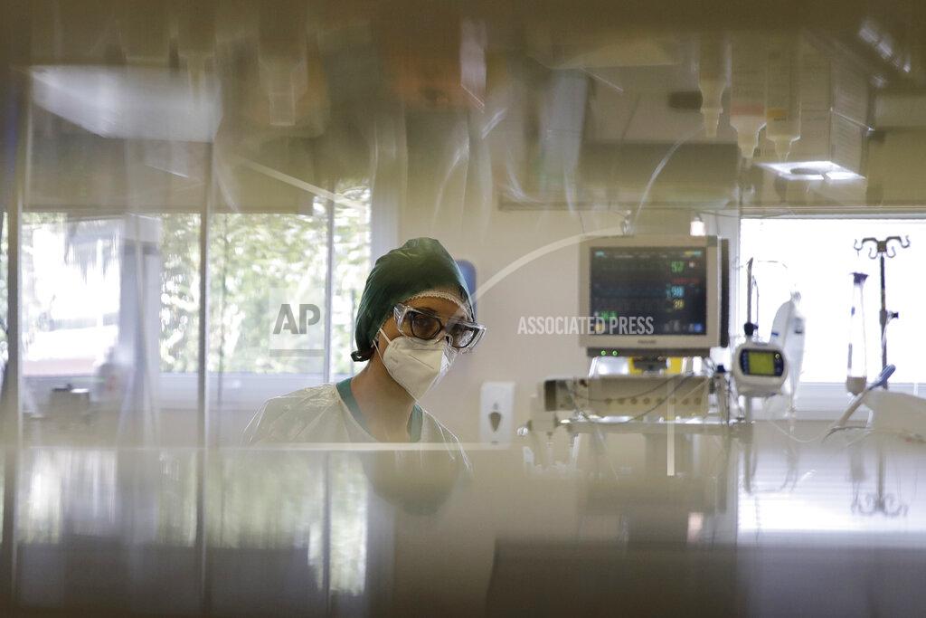 Luca Bruno Paramedic Alessandra works at the Intensive Care Unit of the Varese’s Circolo Hospital, in Varese, Italy, Friday, Nov. 6, 2020. During Italy's autumn pandemic resurgence, concern is falling less on intensive care wards and more on regular medical wards, as eight regions have seen the needle move alarmingly into the red-alert zone with more than half of hospital beds dedicated to coronavirus patients. (AP Photo/Luca Bruno)