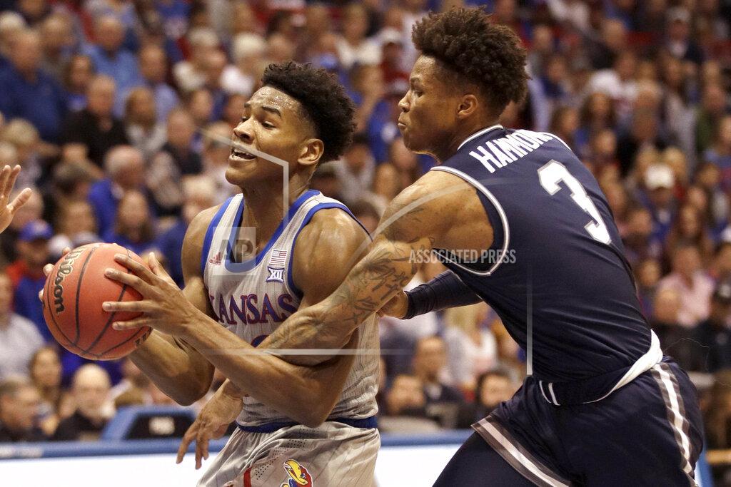 Orlin Wagner Kansas guard Ochai Agbaji, left, is fouled by Monmouth guard Deion Hammond (3) during the first half of an NCAA college basketball game in Lawrence, Kan., Friday, Nov. 15, 2019. (AP Photo/Orlin Wagner)