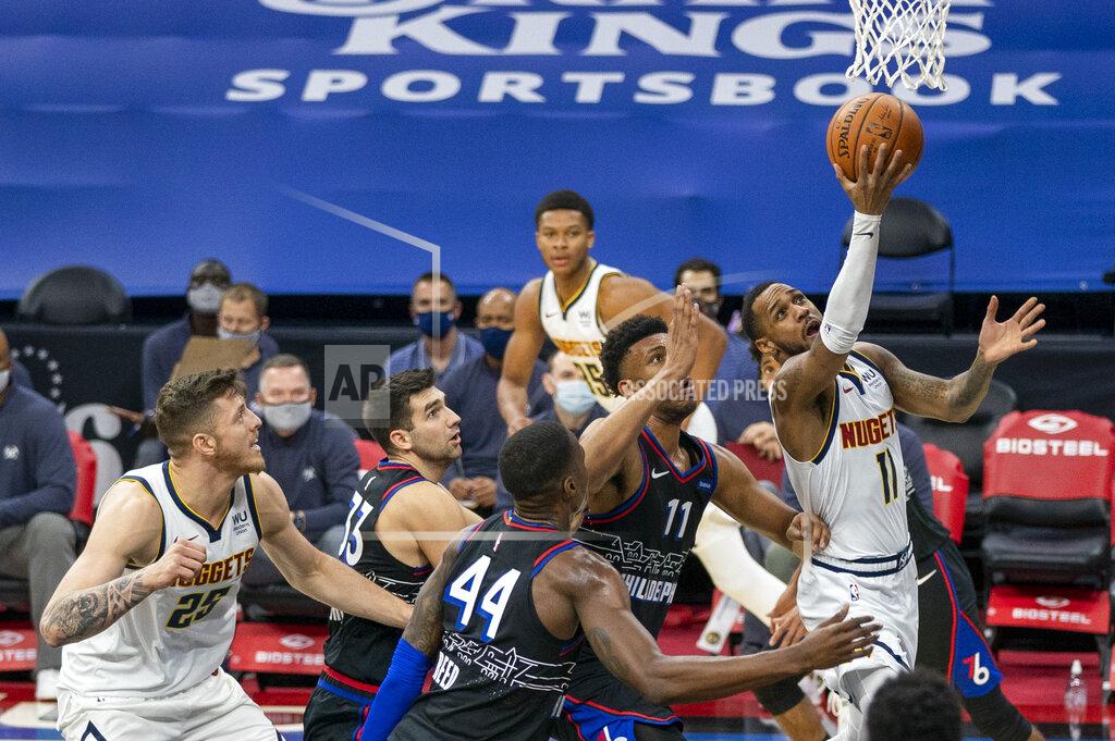 Chris Szagola Denver Nuggets' Monte Morris, right, goes up for the shot against Philadelphia 76ers' Tony Bradley, center left, and Paul Reed, center, during the first half of an NBA basketball game, Saturday, Jan. 9, 2021, in Philadelphia. (AP Photo/Chris Szagola)