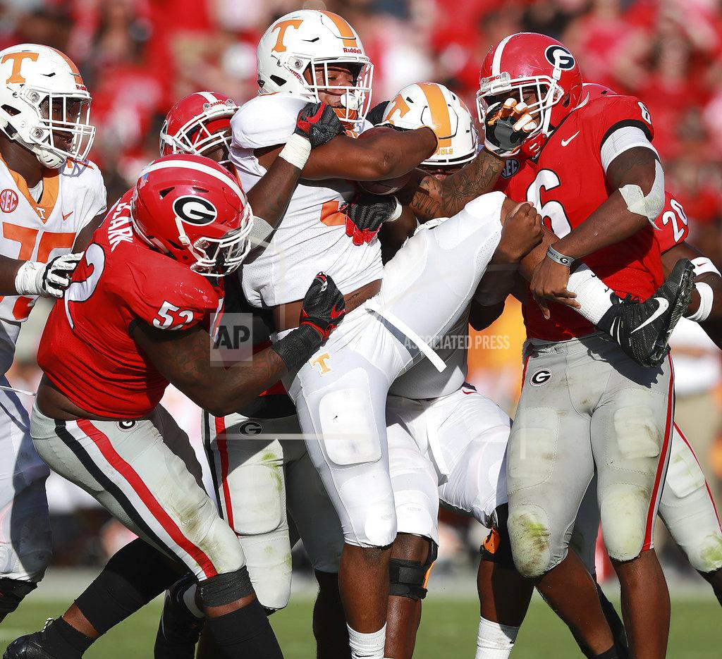 Curtis Compton Georgia defenders, Tyler Clark, left, and Natrez Patrick, right, wrap up Tennessee running back Jeremy Banks at the line of scrimmage during the second half in an NCAA college football game Saturday, Sept 29, 2018, in Athens. (Curtis Compton/Atlanta Journal-Constitution via AP)