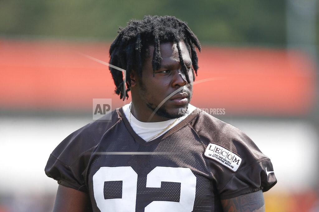 FILE - In this Aug. 14, 2018, file photo, Cleveland Browns defensive end Chad Thomas walks out to the field during NFL football training camp in Berea, Ohio. Browns defensive end Chad Thomas sustained a neck injury in practice Monday, Aug. 12, 2019, and is undergoing further tests at a hospital.(AP Photo/Ron Schwane, File)