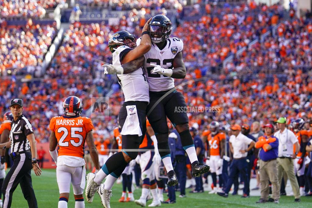 Jack Dempsey Jacksonville Jaguars running back Ryquell Armstead, right, celebrates with quarterback Gardner Minshew after scoring a touchdown during the second half of an NFL football game against the Denver Broncos, Sunday, Sept. 29, 2019, in Denver. (AP Photo/Jack Dempsey)