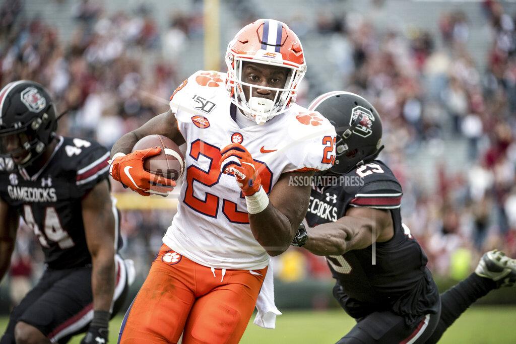 Sean Rayford Clemson running back Lyn-J Dixon (23) carries the ball against South Carolina defensive back J.T. Ibe (29) during the second half of an NCAA college football game Saturday, Nov. 30, 2019, in Columbia, S.C. Clemson defeated South Carolina 38-3. (AP Photo/Sean Rayford)