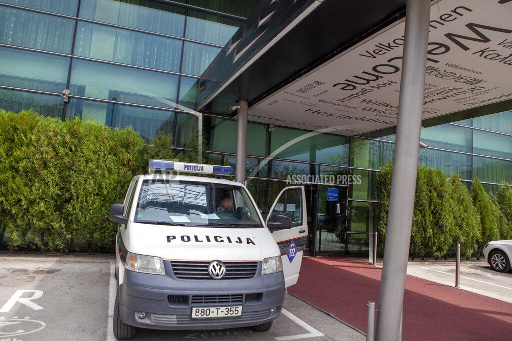 Almir Alic A police vehicle is parked in front of a hotel in Zenica, central Bosnia, Monday, April 20, 2020. Several dozen people in Bosnia are on a hunger strike to protest being quarantined in a hotel on suspicion they might be carrying the new coronavirus. The group of some 80 Bosnians work abroad and when they returned to the country they were placed under a 28-day quarantine in a hotel in the central town of Zenica. (AP Photo/Almir Alic)
