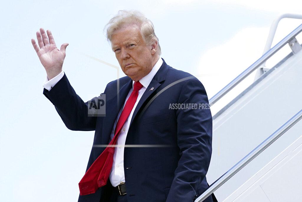 Evan Vucci President Donald Trump waves as he arrives on Air Force One at Austin Straubel International Airport in Green Bay, Wis., Thursday, June 25, 2020. (AP Photo/Evan Vucci)