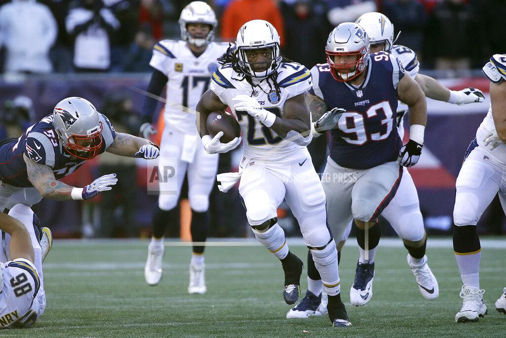 Elise Amendola Los Angeles Chargers running back Melvin Gordon (28) runs from New England Patriots defensive tackle Lawrence Guy (93) during the first half of an NFL divisional playoff football game, Sunday, Jan. 13, 2019, in Foxborough, Mass. (AP Photo/Elise Amendola)