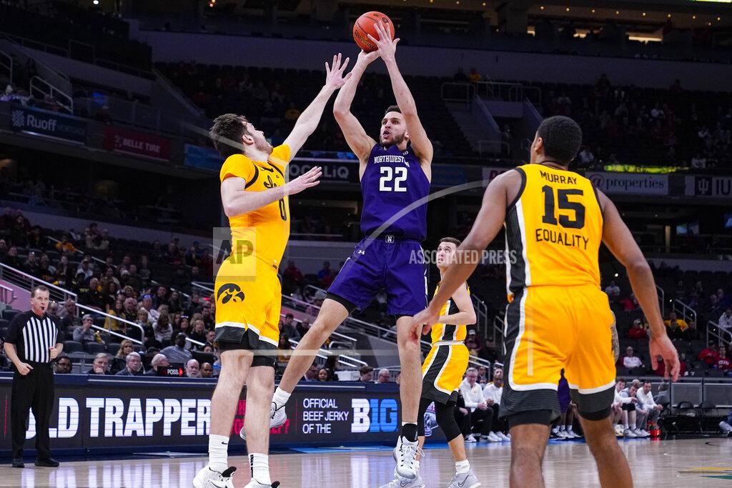Michael Conroy Northwestern forward Pete Nance (22) shoots over Iowa forward Filip Rebraca (0) in the second half of an NCAA college basketball game at the Big Ten Conference tournament in Indianapolis, Thursday, March 10, 2022. Iowa defeated Northwestern 112-76. (AP Photo/Michael Conroy)