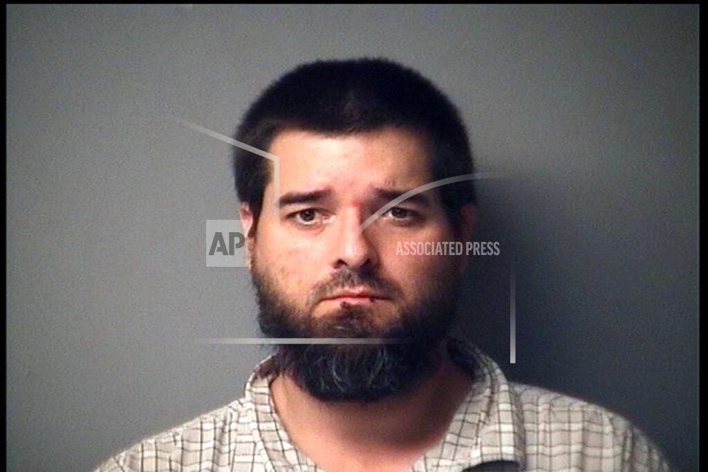 Uncredited CORRECTS CHARGES - In a photo provided by the Antrim County Sheriff, Eric Molitor is shown in a booking photo. Molitor is one of several charged Thursday, Oct. 8, 2020, in state court for allegedly seeking to storm the Michigan Capitol and seek a “civil war.” (Antrim County Sheriff via AP)