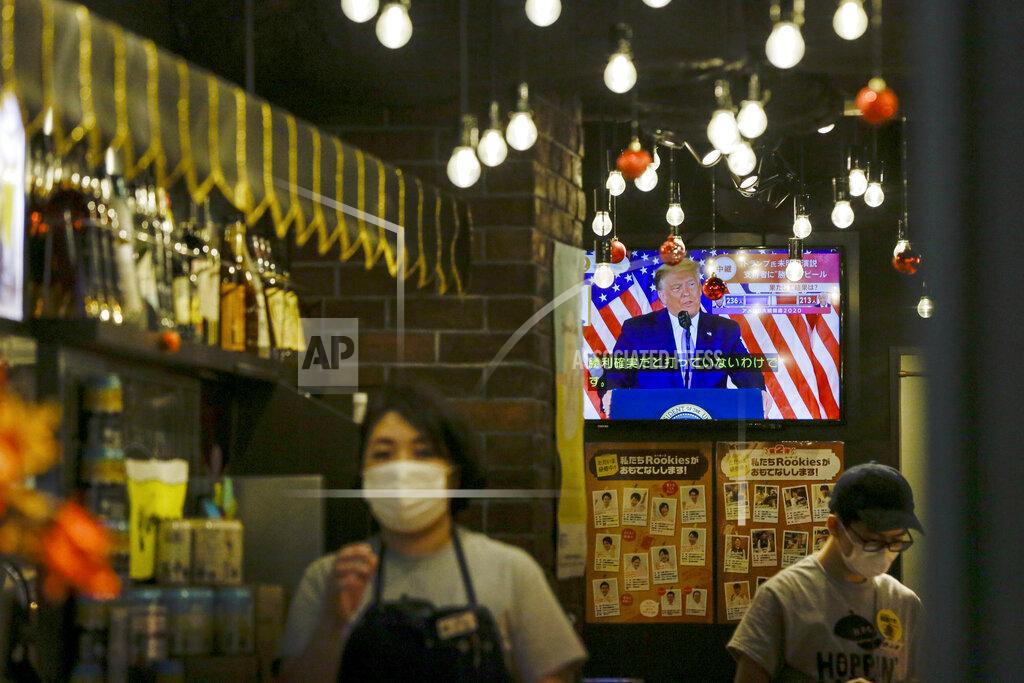 Kiichiro Sato President Donald Trump speaking from the White House is projected on a television at a restaurant Wednesday, Nov. 4, 2020 in Tokyo. (AP Photo/Kiichiro Sato)