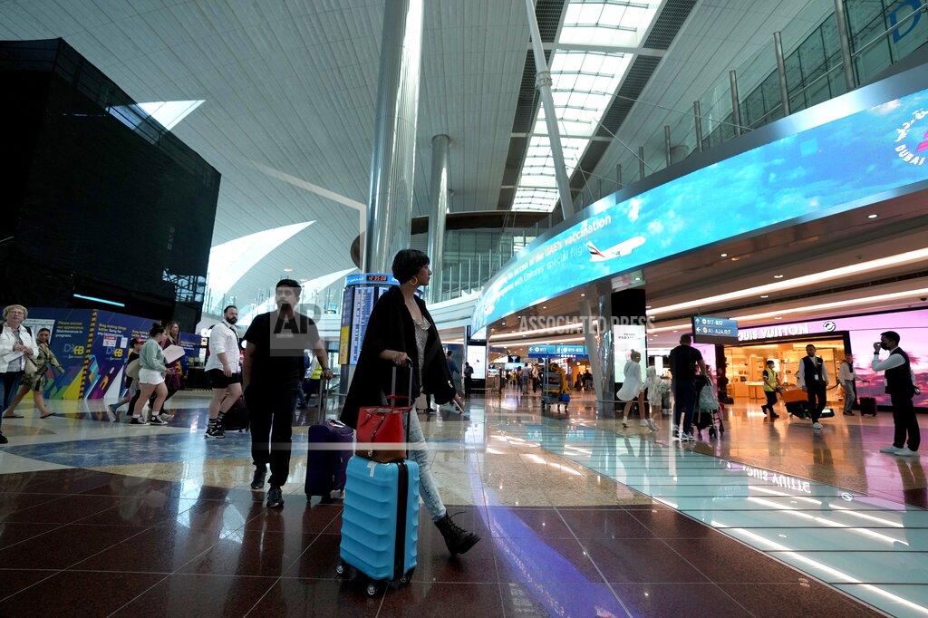 Kamran Jebreili FILE - Passengers arrive at the Dubai Airport terminal 3, in Dubai, United Arab Emirates, on Oct. 25, 2022. Just as soccer fans going to a game in a European city might take a metro, tens of thousands of foreigners attending the World Cup in Qatar this month are commuting to matches by airplane. (AP Photo/Kamran Jebreili, File)