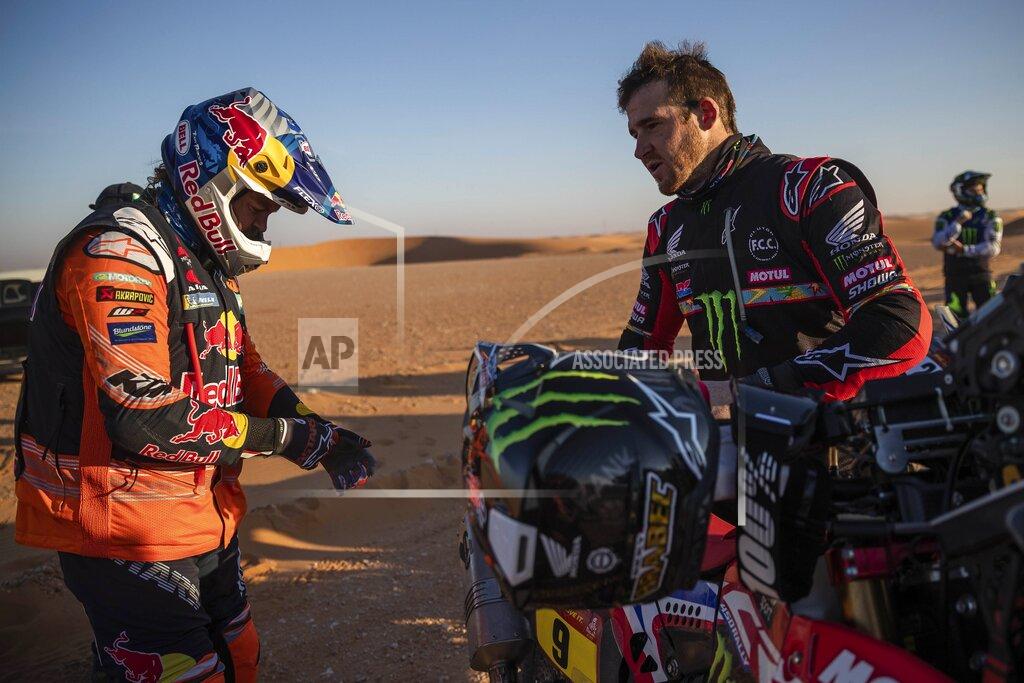Bernat Armangue Ricky Brabec of United States, right, talks with Toby Price of Australia before the start of stage twelve of the Dakar Rally between Haradth and Qiddiya, Saudi Arabia, Friday, Jan. 17, 2020. (AP Photo/Bernat Armangue)