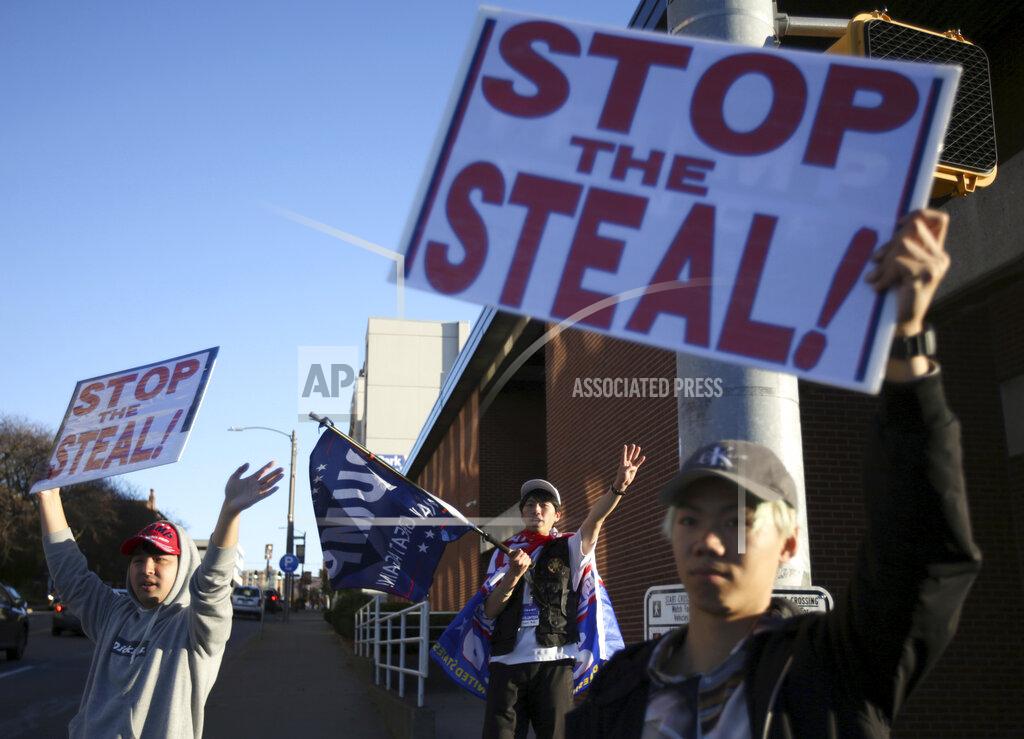 Jake Danna Stevens A group of Japanese nationals gather on the streets of Scranton, Pa., to show their support for President Donald Trump on Monday, Nov. 9, 2020. (Jake Danna Stevens/The Times-Tribune via AP)