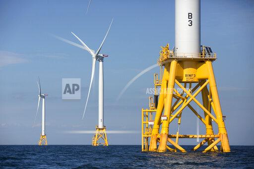 FILE - In this Aug. 15, 2016 file photo, three of Deepwater Wind's five turbines stand in the water off Block Island, R.I, the nation's first offshore wind farm. Interior Secretary Deb Haaland says the Biden administration will hold lease sales for up to seven offshore wind farms on the East and West coasts and in the Gulf of Mexico in the next four years. The projects are part of the administration's plan to deploy 30 gigawatts of offshore wind energy by 2030, generating enough electricity to power more than 10 million homes. (AP Photo/Michael Dwyer, File)
