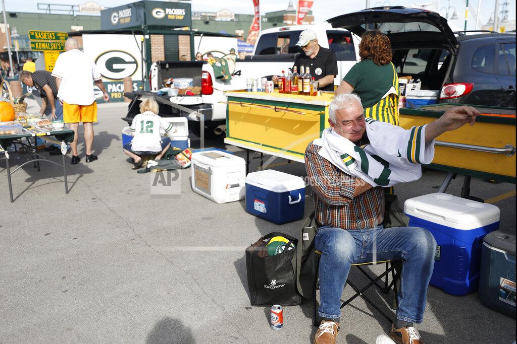 Jeffrey Phelps A Green Bay Packers fan puts on a jersey outside Lambeau Field before an NFL football game between the Packers and the Philadelphia Eagles, Thursday, Sept. 26, 2019, in Green Bay, Wis. (AP Photo/Jeffrey Phelps)