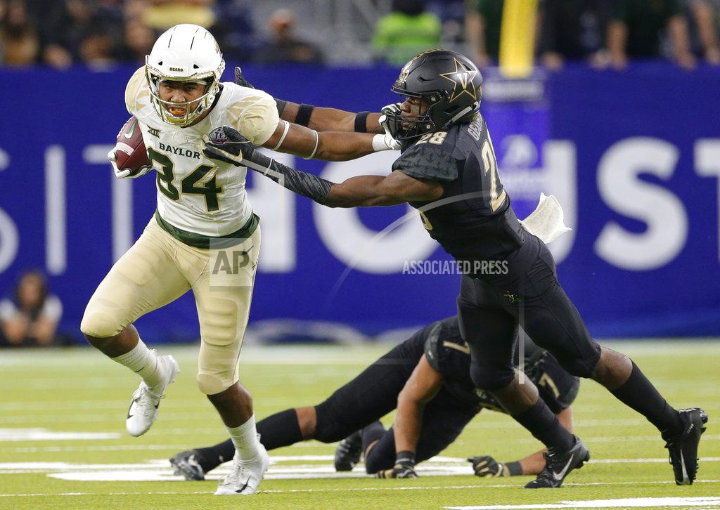 Michael Wyke Baylor wide receiver Marques Jones (84) pushes off the tackle attempt by Vanderbilt defensive back Allan George (28) on his go-ahead and eventual game-winning touchdown run during the second half of the Texas Bowl NCAA college football game, Thursday, Dec. 27, 2018, in Houston. Baylor won 45-38. (AP Photo/Michael Wyke)
