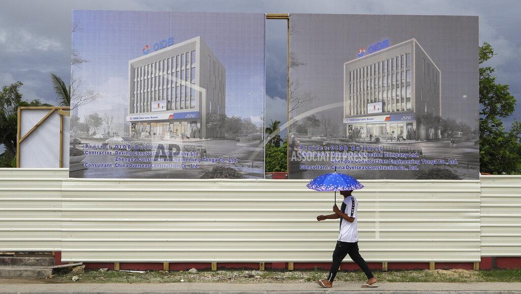 Mark Baker FILE - In this April 10, 2019, file photo, a man walks past a development site for a Chinese Investment bank in Nuku'alofa, Tonga. The Sydney-based think tank Lowy Institute released its annual Pacific Aid Map, Wednesday, Sept. 29, 2021, saying China gave significantly less aid to the Pacific in recent years despite Beijing’s diplomatic efforts to increase its influence in the region. (AP Photo/Mark Baker, File)