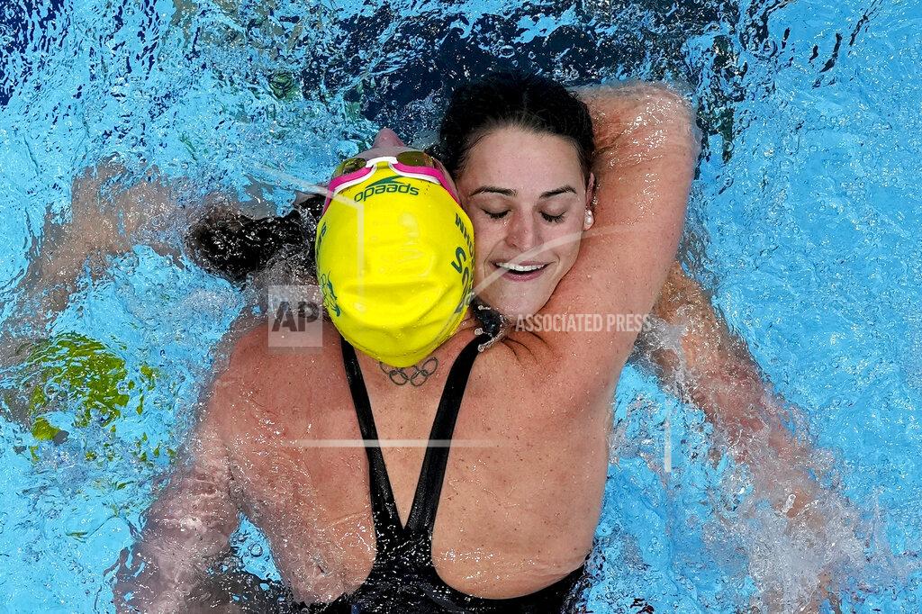 Morry Gash Kaylee McKeown, of Australia, is congratulated by teammate Emily Seebohm after winning the final of the women's 100-meter backstroke at the 2020 Summer Olympics, Tuesday, July 27, 2021, in Tokyo, Japan. (AP Photo/Morry Gash)