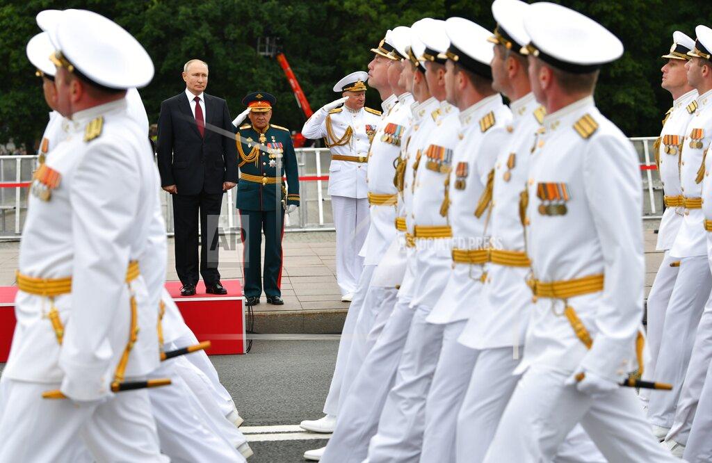 Alexei Nikolsky Russian President Vladimir Putin, left, and Russian Defense Minister Sergei Shoigu, center, attend the Navy Day parade in St.Petersburg, Russia, Sunday, July 25, 2021. (Alexei Nikolsky, Sputnik, Kremlin Pool Photo via AP)
