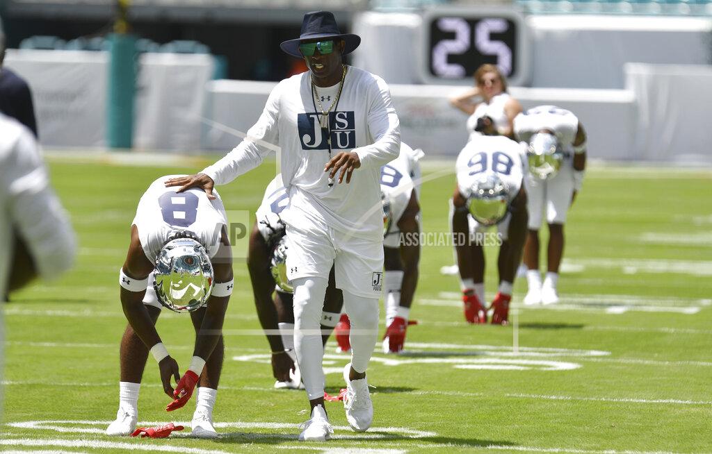 Jim Rassol Jackson State head coach Deion Sanders greets his team during warmups before an NCAA college football game against Florida A&M, Sunday, Sept. 5, 2021, in Miami Gardens, Fla. (AP Photo/Jim Rassol)