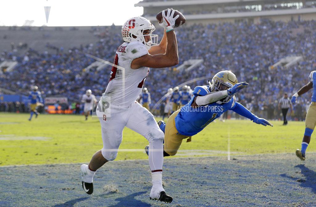 Marcio Jose Sanchez Stanford wide receiver JJ Arcega-Whiteside, left, catches a touchdown next to UCLA defensive back Darnay Holmes (1) during the second half of an NCAA college football game Saturday, Nov. 24, 2018, in Pasadena, Calif. (AP Photo/Marcio Jose Sanchez)
