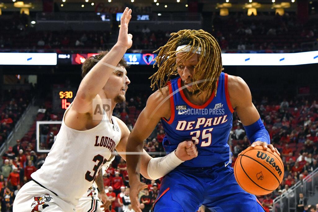 Timothy D. Easley DePaul forward Brandon Johnson (35) tries to get past Louisville forward Matt Cross (33) during the first half of an NCAA college basketball game in Louisville, Ky., Friday, Dec. 10, 2021. (AP Photo/Timothy D. Easley)