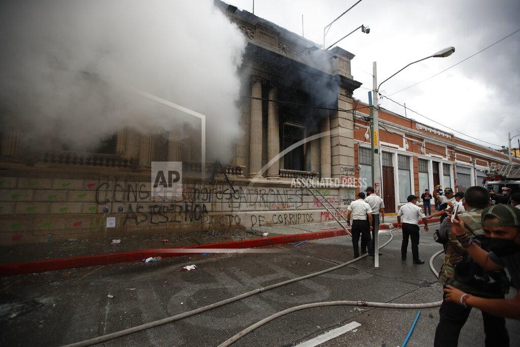 Moises Castillo Clouds of smoke shoot out from the Congress building after protesters set a part of the building on fire, in Guatemala City, Saturday, Nov. 21, 2020. Hundreds of protesters were protesting in various parts of the country Saturday against Guatemalan President Alejandro Giammattei and members of Congress for the approval of the 2021 budget that reduced funds for education, health and the fight for human rights. (AP Photo/Moises Castillo)