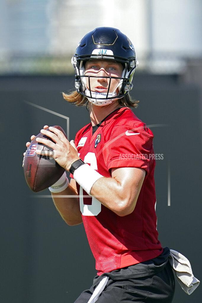 John Raoux Jacksonville Jaguars quarterback Trevor Lawrence (16) looks for a receiver during NFL football practice, Saturday, July 31, 2021, in Jacksonville, Fla. (AP Photo/John Raoux)