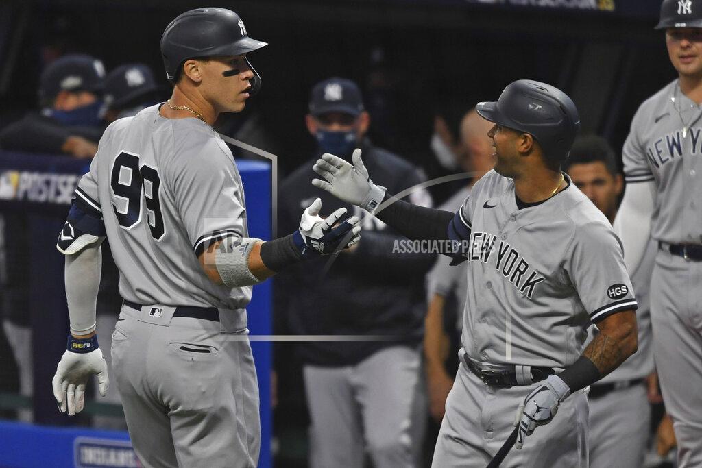 David Dermer New York Yankees' Aaron Judge (99) is congratulated by Aaron Hicks after hitting a two-run home run off Cleveland Indians starting pitcher Shane Bieber (57) in the first inning of Game 1 of an American League wild-card baseball series, Tuesday, Sept. 29, 2020, in Cleveland. (AP Photo/David Dermer)