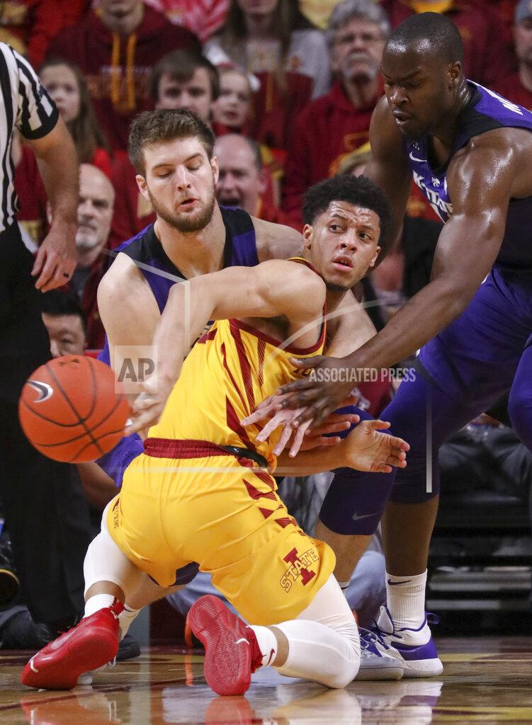 Justin Hayworth Iowa State guard Lindell Wigginton tosses a behind the back pass after losing his balance and falling down as he was defended by Kansas State forward Dean Wade and Kansas State forward Makol Mawien during the second half of an NCAA college basketball game, Saturday, Jan. 12, 2019, in Ames, Iowa. Kansas State won 58-57. (AP Photo/Justin Hayworth)