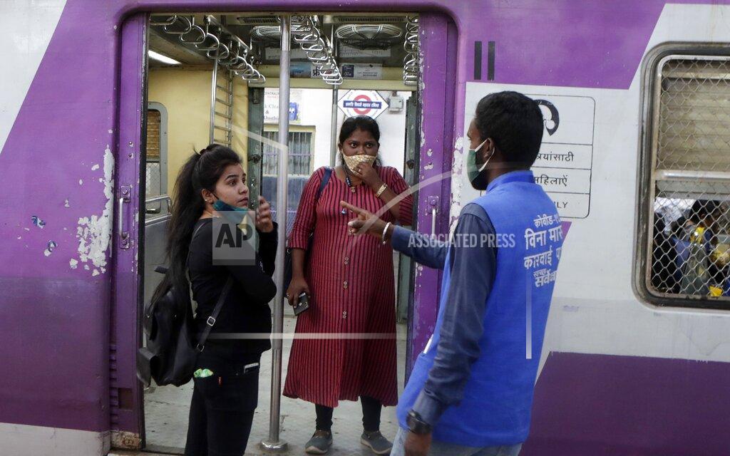 Rajanish Kakade A municipal worker gives a commuter a penalty for not using a face mask at Chhatrapati Shivaji Maharaj Terminus in Mumbai, India, Saturday, Feb. 20, 2021. Health officials have detected a spike in COVID-19 cases in several pockets of Maharashtra state, including in Mumbai, the country's financial capital. (AP Photo/Rajanish Kakade)