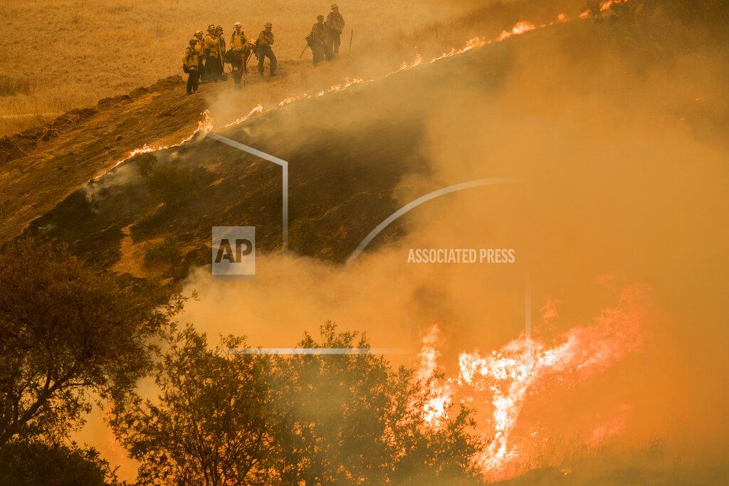Fire crews maintain a backburn to control the River Fire near the Las Palmas neighborhood in Salinas, Calif., Wednesday, Aug. 19, 2020. (AP Photo/Nic Coury)