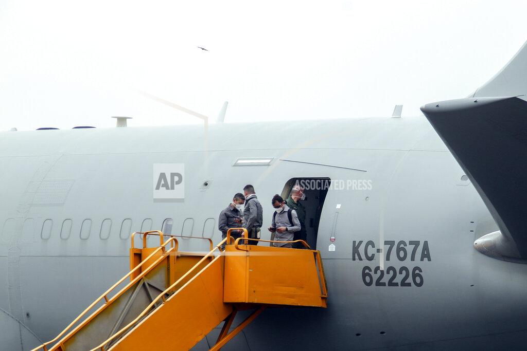 Justin Kabumba Unidentified people stand on the boarding stairs of an airplane after it arrived to transport the bodies of Italian ambassador to Congo Luca Attanasio and Carabinieri officer Vittorio Iacovacci to the capital Kinshasa, at the airport in Goma, North Kivu province, Congo Tuesday, Feb. 23, 2021. Congo has dispatched a team to support investigators on the ground in Goma where the Italian ambassador to Congo, an Italian Carabinieri police officer and their driver were ambushed and killed Monday. (AP Photo/Justin Kabumba)