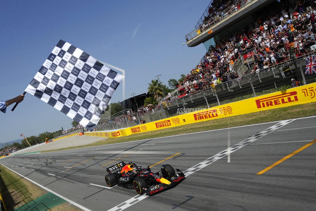 Red Bull driver Max Verstappen of the Netherlands receives the checkered flag as he crosses the finish line to win the Spanish Formula One Grand Prix at the Barcelona Catalunya racetrack in Montmelo, Spain, Sunday, May 22, 2022. (AP Photo/Pool/Manu Fernandez)