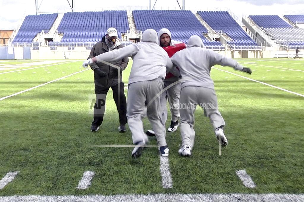Devon Dalton In this image provided by WaV Sports & Entertainment + The NFL Alumni Academy, Mike Tice, left, coaches at the NFL Alumni Academy at Tom Benson Stadium in Canton, Ohio on Nov. 4, 2020. In normal times, NFL teams sometimes must scramble to find players during the season when a wave of injuries or other issues hit. In 2020, multiply those needs exponentially because of the coronavirus pandemic. Helping out the 32 teams on a limited scale, for now, is the NFL Alumni Academy. (Devon Dalton/WaV Sports & Entertainment + The NFL Alumni Academy via AP)