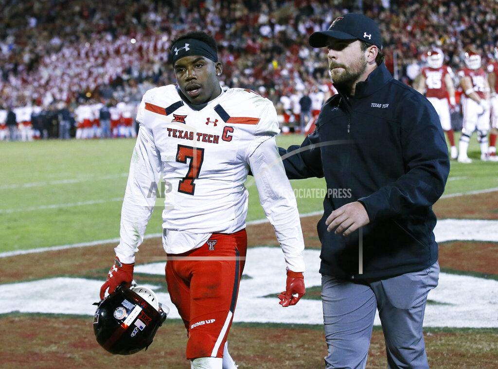 Sue Ogrocki FILE - In this Oct. 28, 2017, file photo, Texas Tech defensive back Jah'Shawn Johnson (7) leaves the game after being ejected following a targeting penalty in the second half of an NCAA college football game against Oklahoma, in Norman, Okla. The NCAA Playing Rules Oversight Panel adjusted the targeting rule in college football, allowing video review officials to overturn calls if any element of the penalty cannot be confirmed. The adjustment to the rule announced Tuesday, April 23, 2019, means there will be no option for letting the call on the field "stand" during a targeting review. It must either be confirmed or overturned. The goal of the rule adjustment is to call targeting more accurately and have fewer players ejected for borderline calls.(AP Photo/Sue Ogrocki, File)