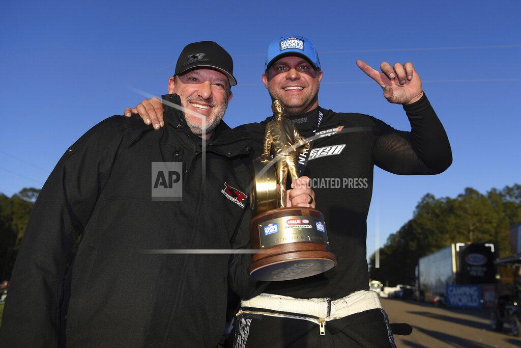 Jerry Foss In this photo provided by the NHRA, Matt Hagan, right, poses with team owner Tony Stewart after winning the Amalie Motor Oil NHRA Gatornationals Funny Car auto race at Gainesville Raceway, in Gainesville, Fla., Sunday, March 13, 2022. Hagan defeated Blake Alexander in the final round to give Tony Stewart Racing its first NHRA Camping World Drag Racing Series victory. (Jerry Foss/NHRA via AP)