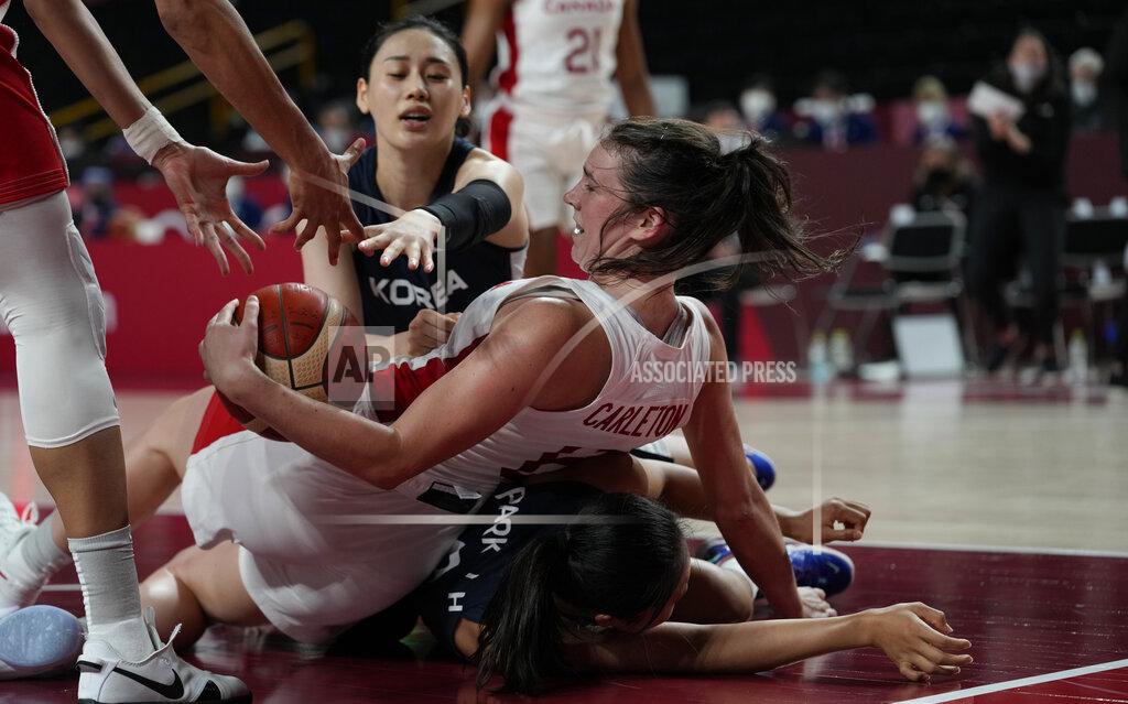 Eric Gay Canada's Bridget Carleton (6), center, falls on South Korea's Jihyun Park (9) in an attempt to grab the loose ball during women's basketball preliminary round game at the 2020 Summer Olympics, Thursday, July 29, 2021, in Saitama, Japan. (AP Photo/Eric Gay)