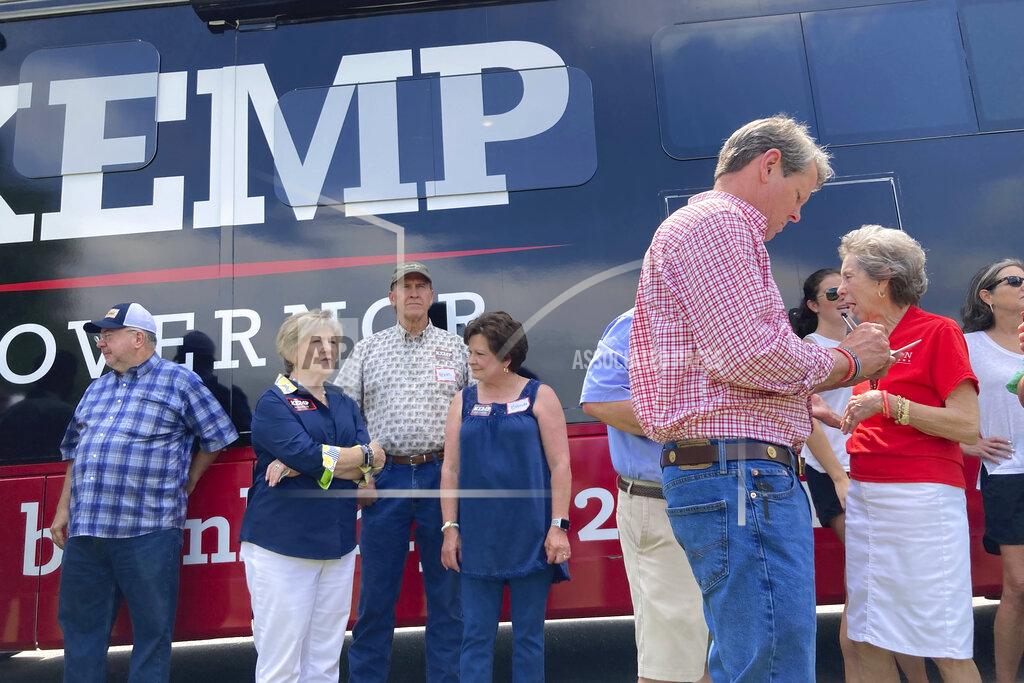 Jeff Amy Georgia Gov. Brian Kemp makes notes before giving a speech on Saturday, May 21, 2022, in Watkinsville, Ga. The Republican Kemp is seeking to beat former U.S. Sen David Perdue and others in a Republican primary for governor on Tuesday, May 24, 2022 (AP Photo/Jeff Amy)