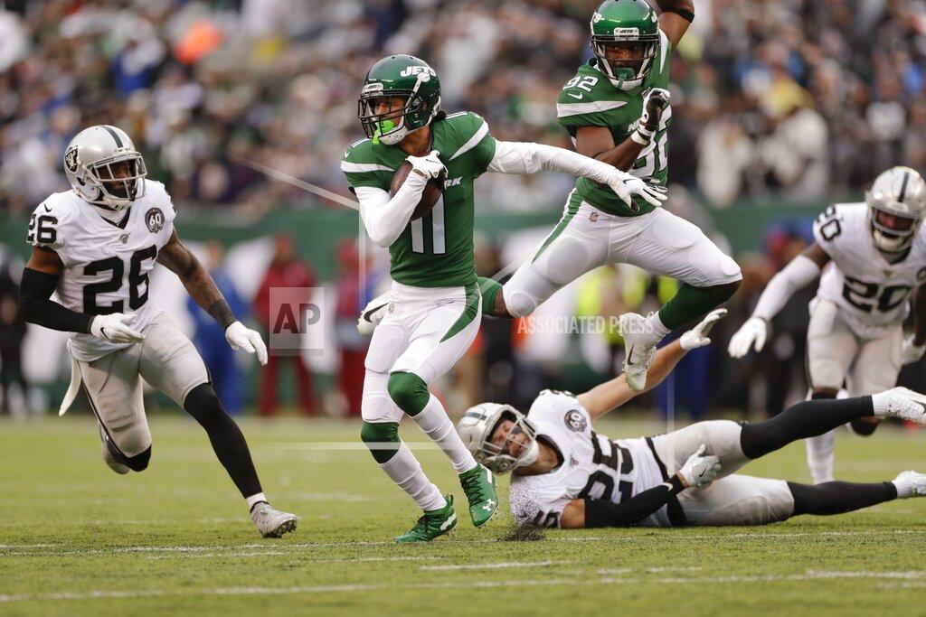 Adam Hunger New York Jets wide receiver Robby Anderson (11) runs away from Oakland Raiders free safety Erik Harris (25) and Nevin Lawson (26) during the first half of an NFL football game Sunday, Nov. 24, 2019, in East Rutherford, N.J. (AP Photo/Adam Hunger)