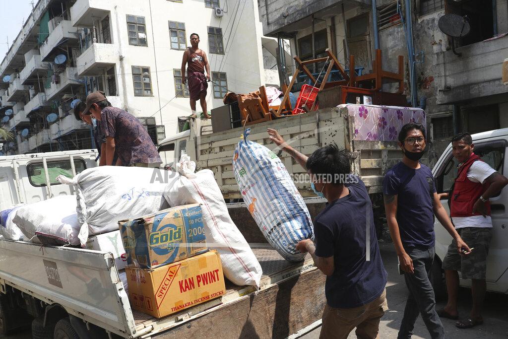Uncredited State railway employee load belongings after being evicted from their homes Saturday, March 20, 2021, in Mandalay, Myanmar. State railway workers in Mandalay have been threatened with eviction to force them to end their support for the Civil Disobedience Movement (CDM) against military rule. (AP Photo)
